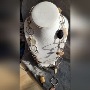 Very long silver-tone ring necklace with various crystal and stone accents